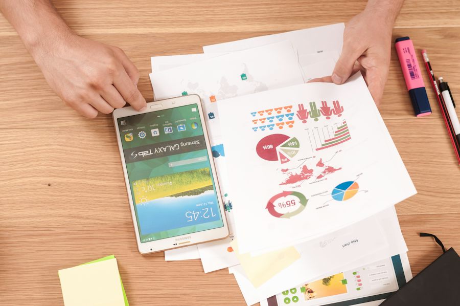 Printed charts and graphs spread across a desk